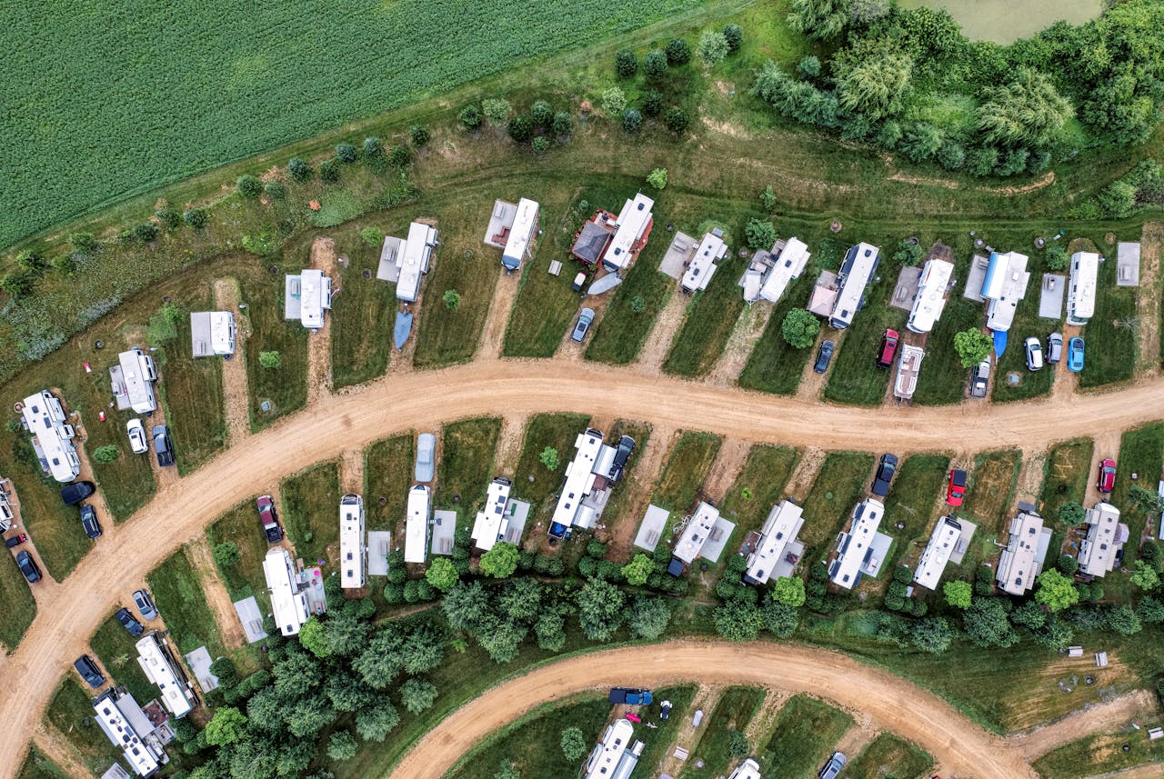 about-us-01 Top-down drone shot of campervans parked in a lush green camping site in Nelson, Wisconsin.