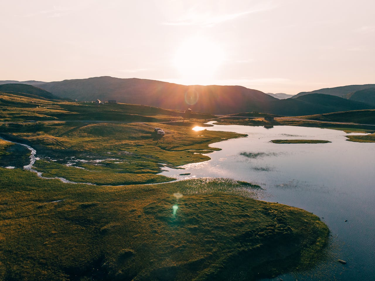 services-02 A peaceful sunrise over a Norwegian lake landscape with hills and reflections. Perfect for travel and nature enthusiasts.